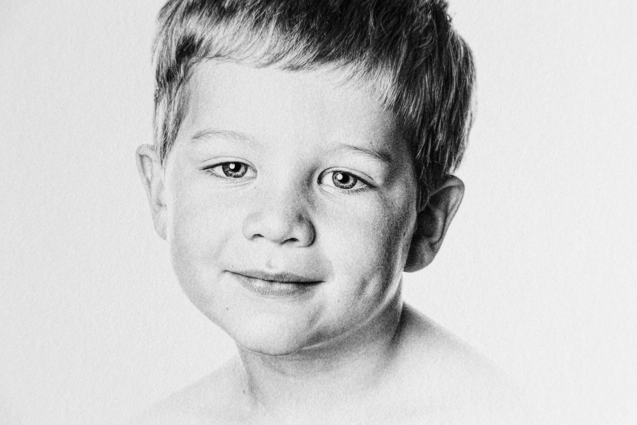 Raleigh NC heirloom photography — black and white head and shoulders portrait of a smiling child.