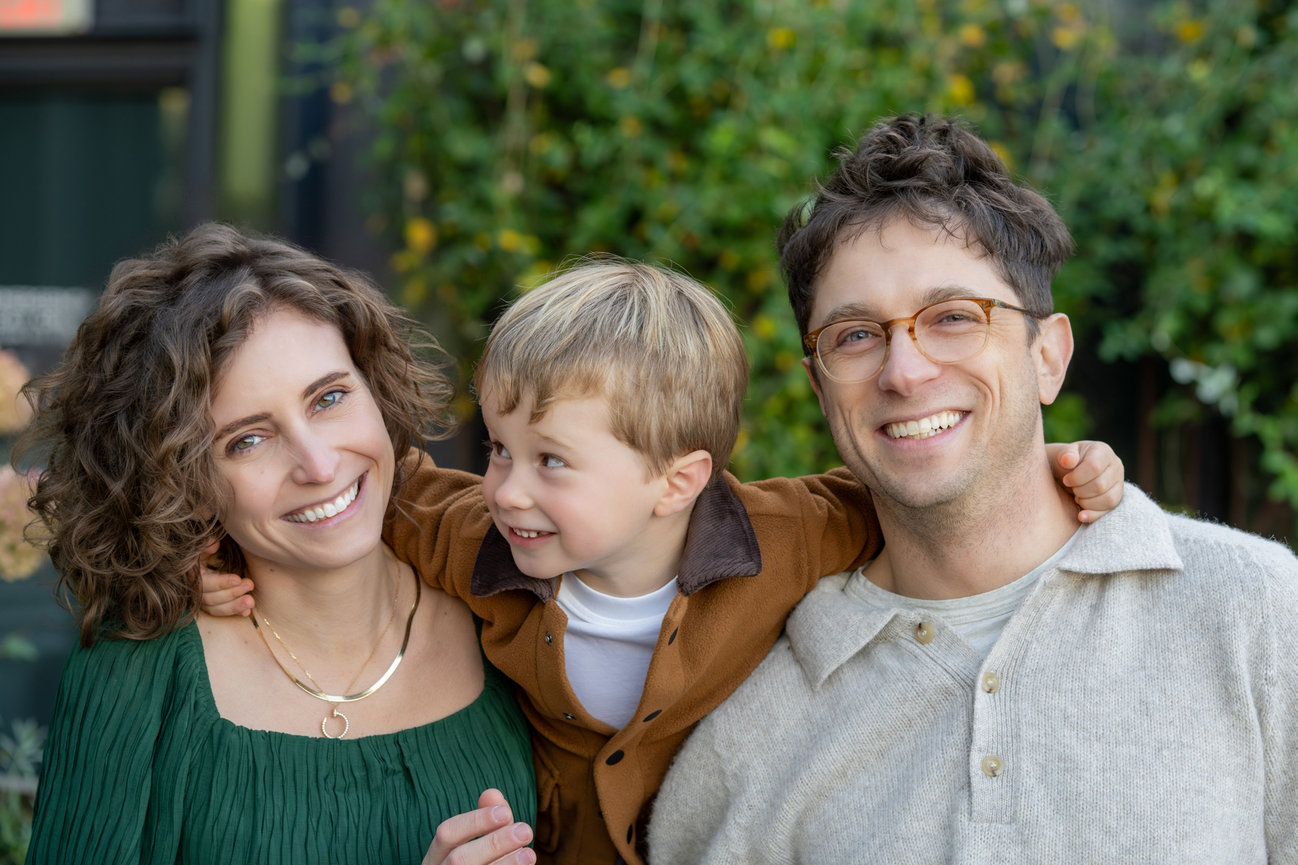 Family smiling outdoors