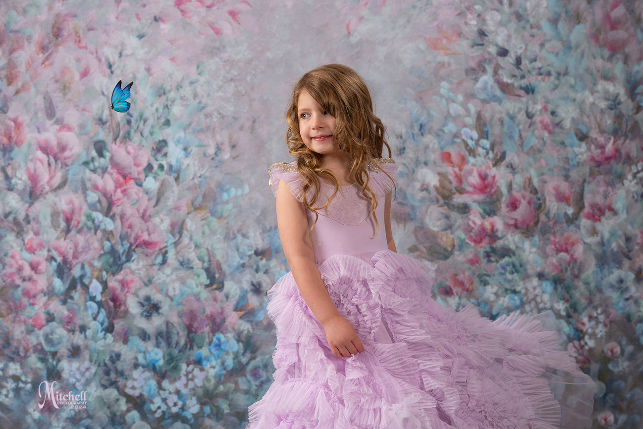 Young girl wearing Dollcake dress with flowers in background by Mitchell Photography