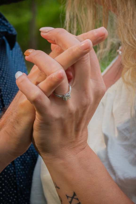 Close-up of a couple holding hands with rings