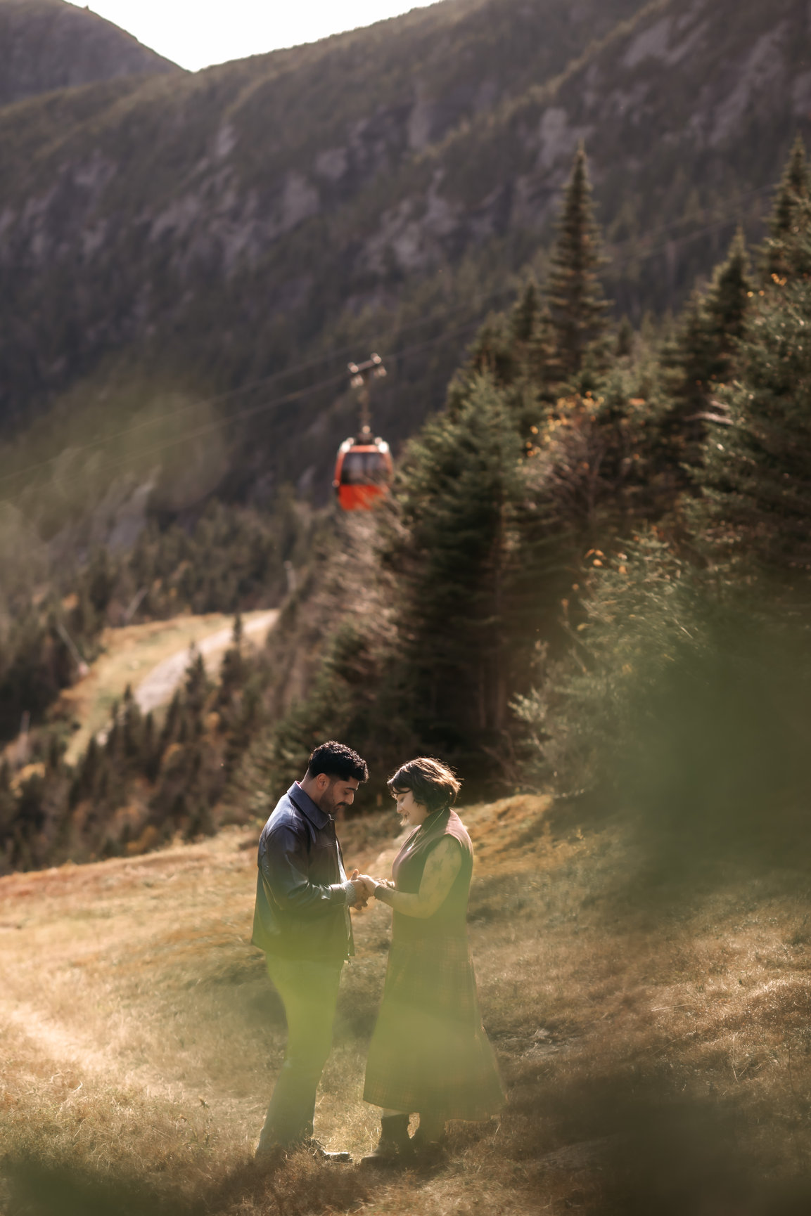 Engaged couple below the Stowe gondola in fall