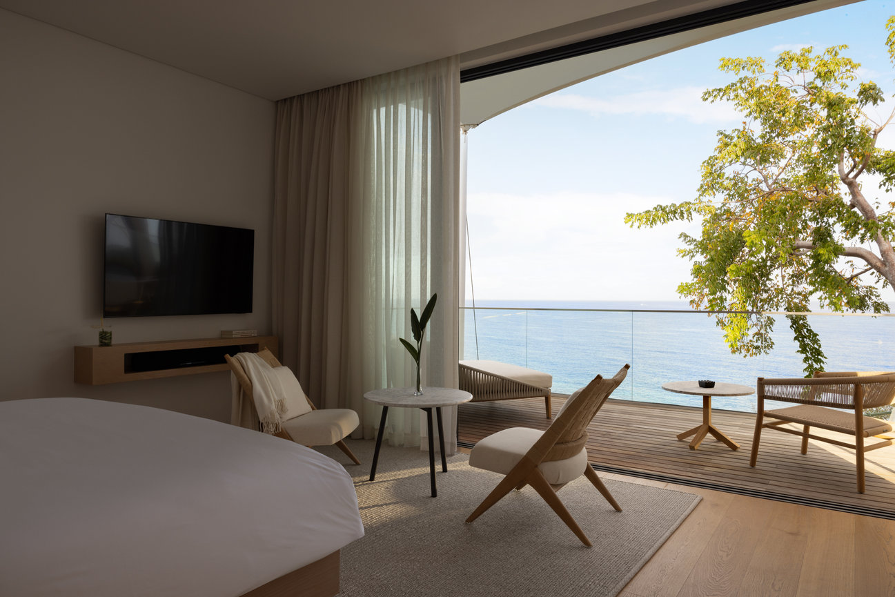 Silversands Beach House Guest Room with simple spacious interior all white with large balcony overlooking the Ocean in the west indies.