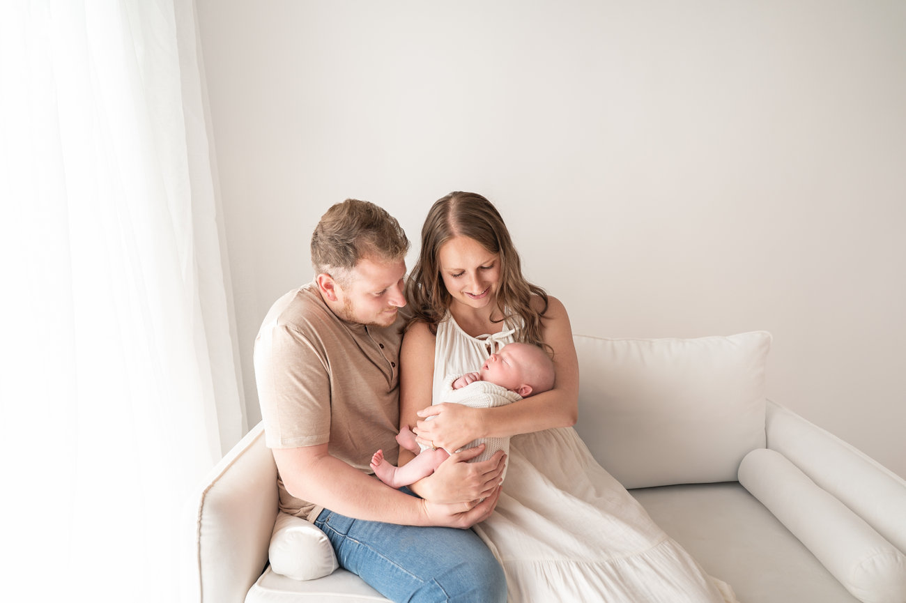 Family holding baby together in Princeton, NJ photography studio