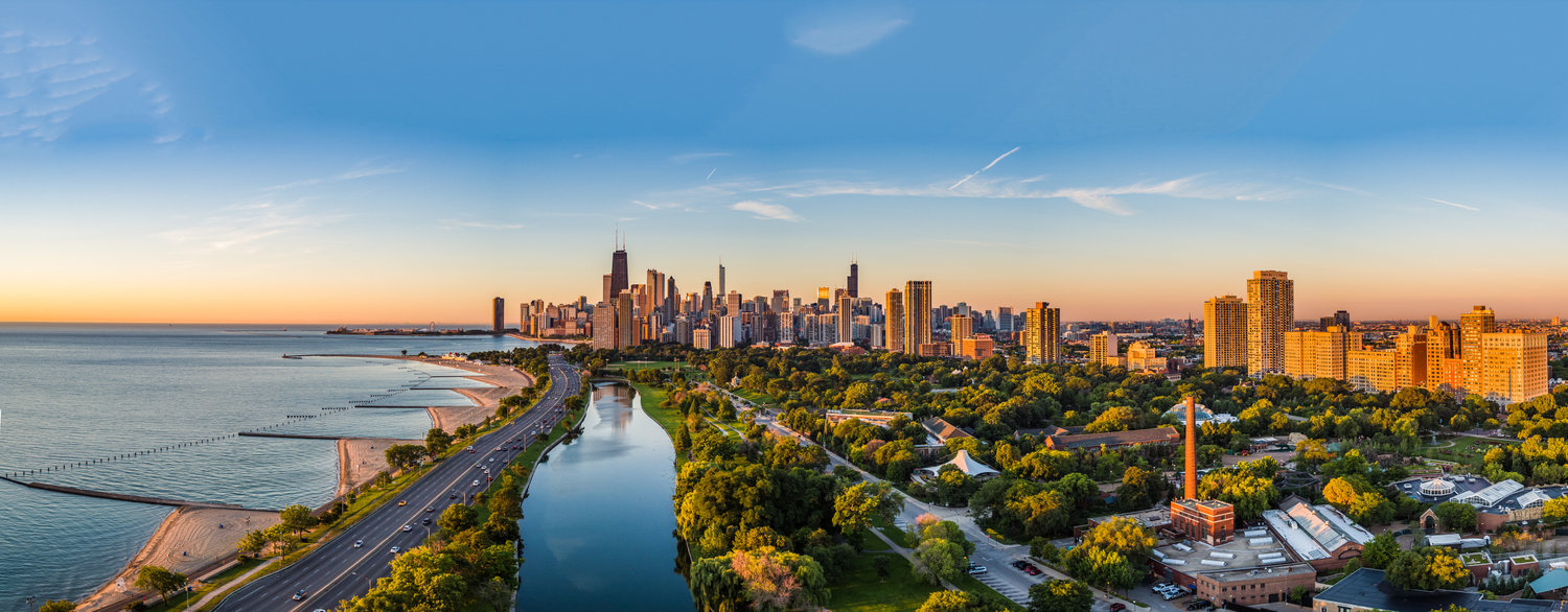 Aerial view of city along lakefront at sunset
