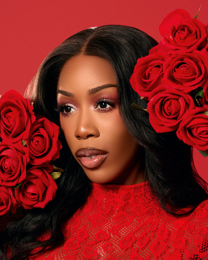 Close-up of woman with roses on red background