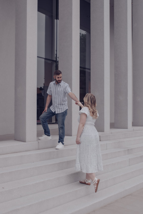 Couple holding hands on stone steps