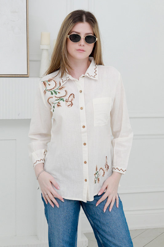 Model wearing embroidered linen summer shirt and sunglasses styled for spring summer fashion photoshoot in Toronto studio.