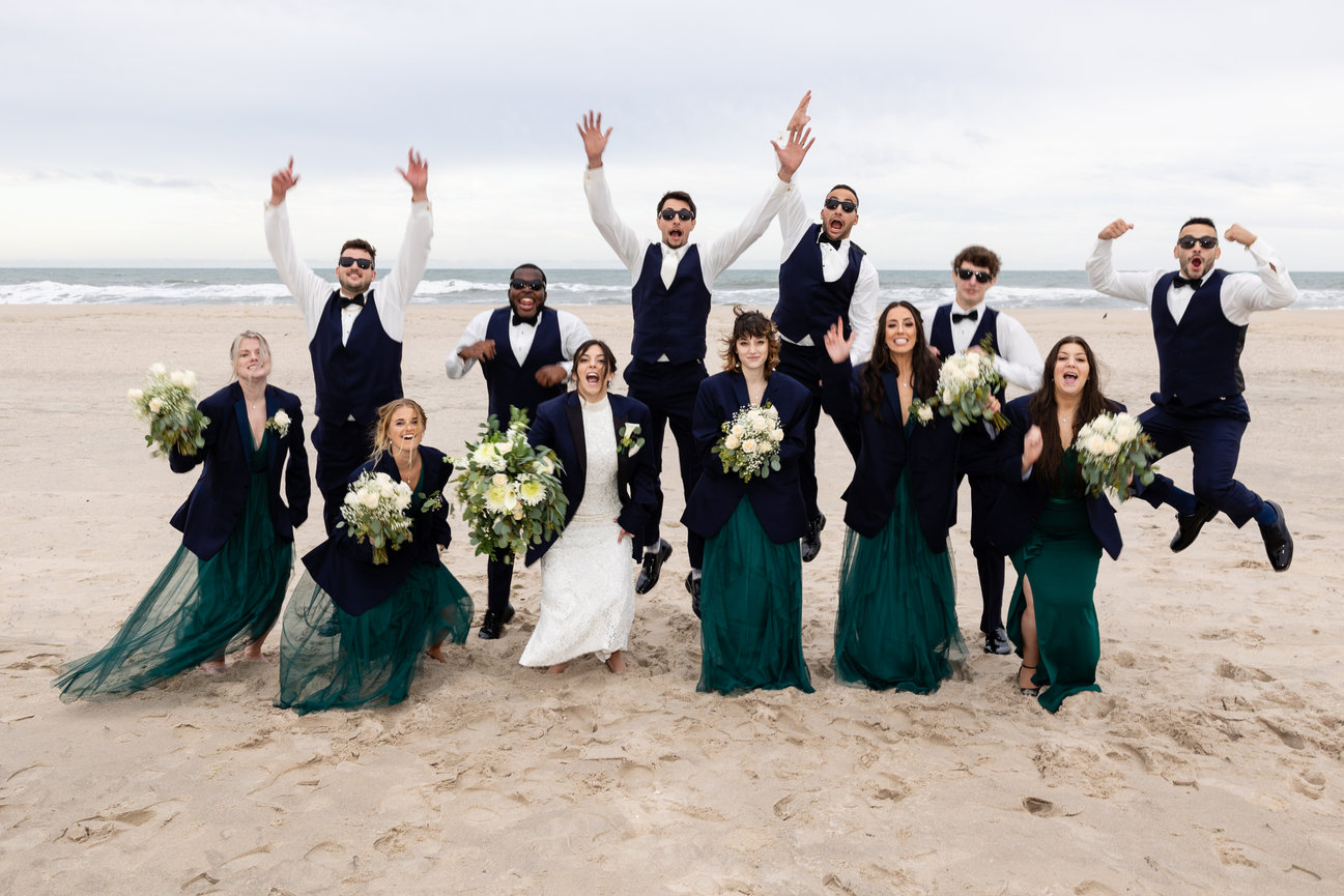 Bridal party cheering together on a Jersey Shore beach