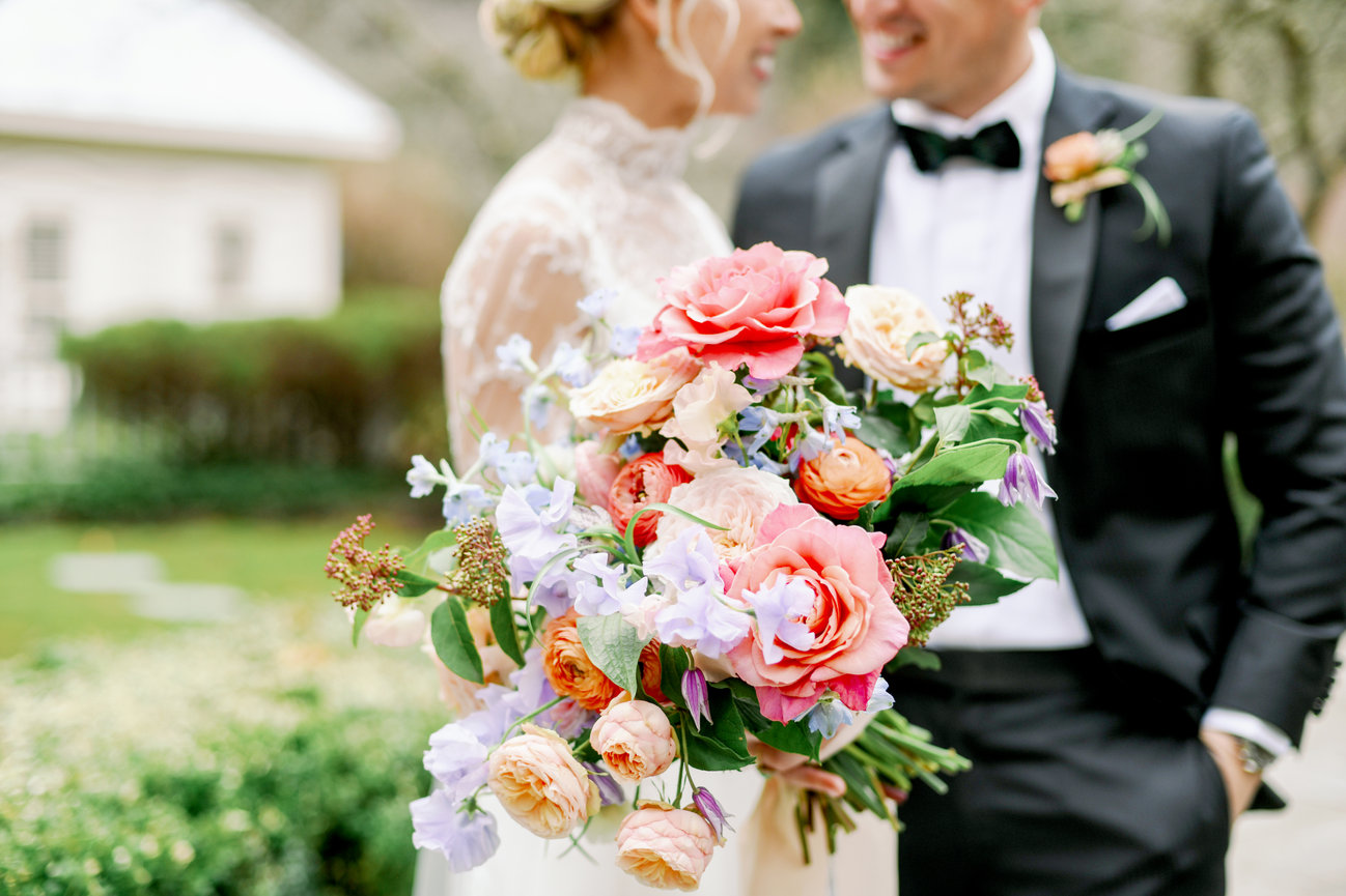 Bride and groom at the Farm at Old Edwards in North Carolina with beautiful colorful bridal bouquet by Floressence. Destination wedding photography by Heather Durham.
