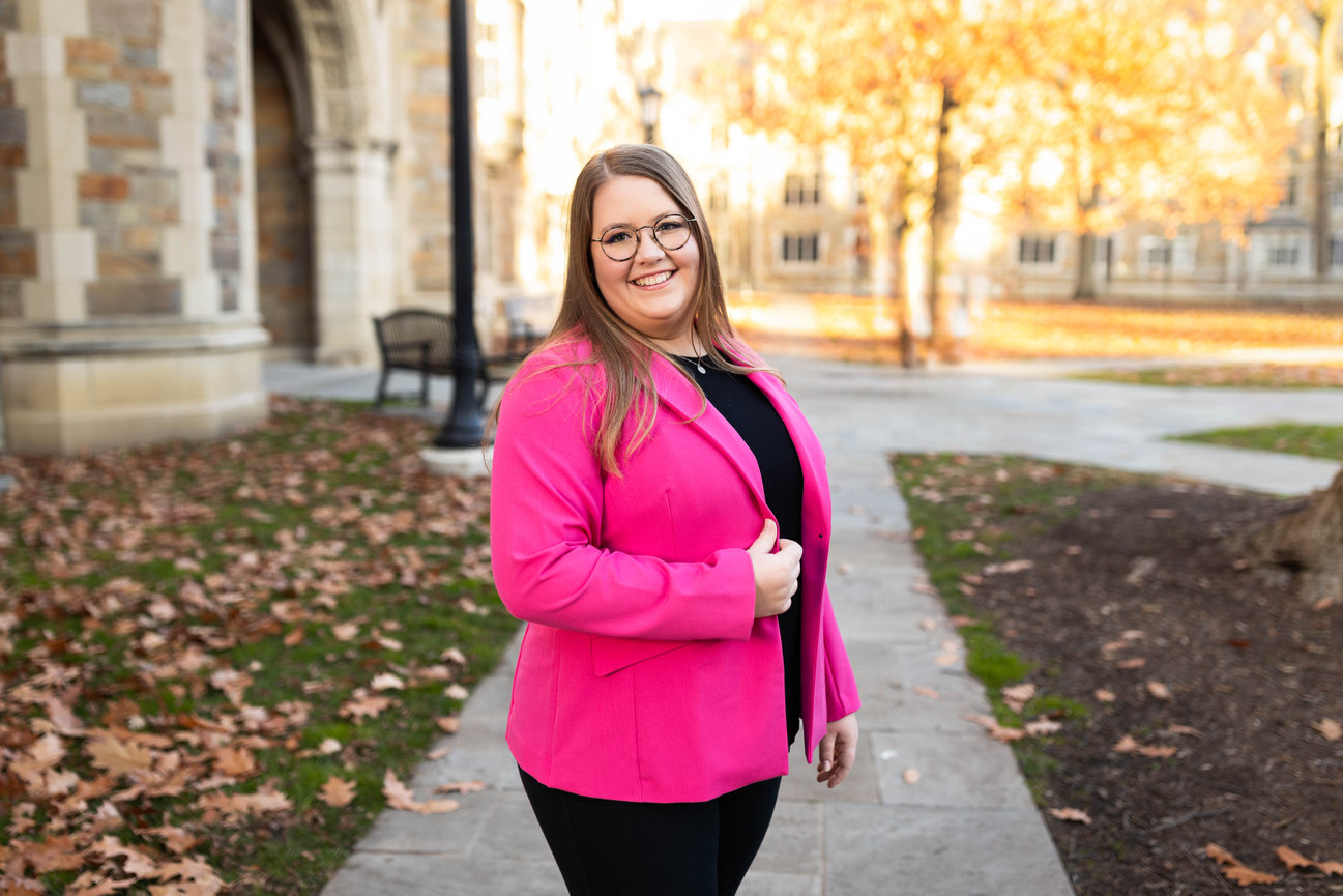Business headshot of young professional with blurred outdoor background