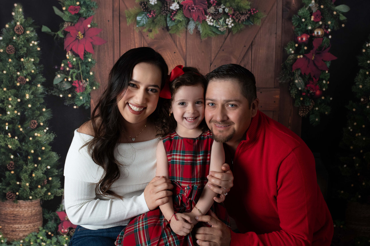 A family posing for Christmas photos