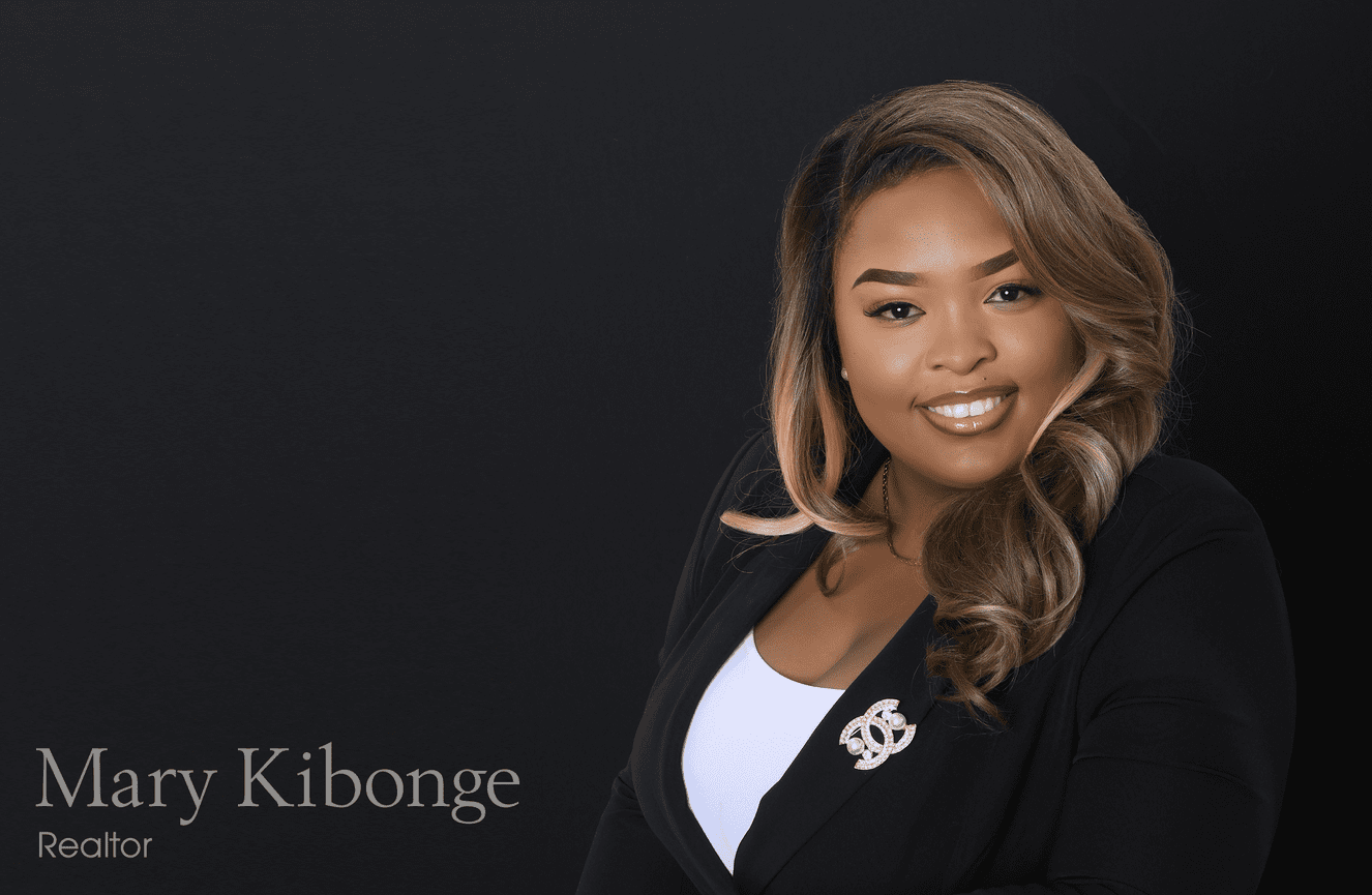 Mary, a realtor, poses for her yard sign photos wearing a sharp black blazer and diamond broach.