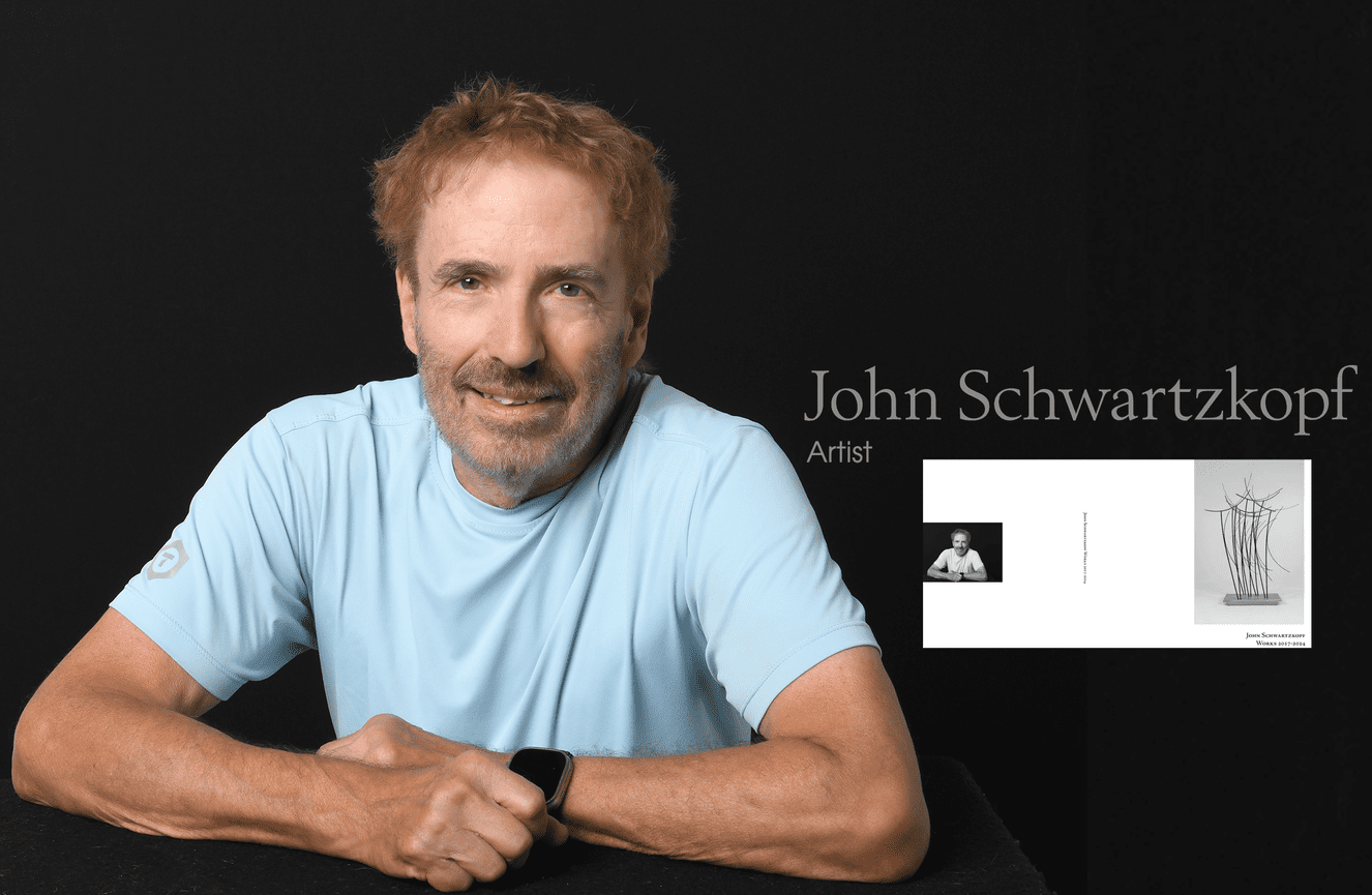 John poses for his artist bio in his book which celebrates 50 years of his work.