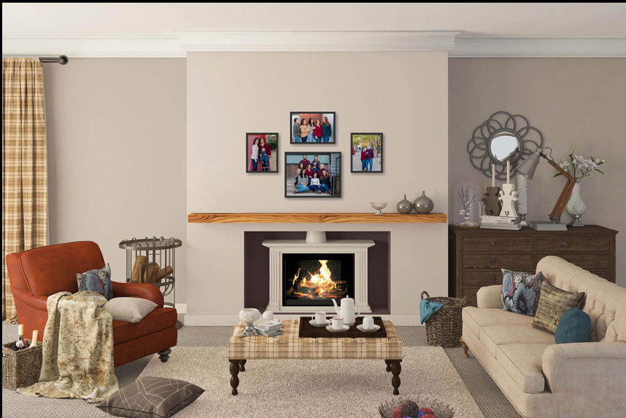 Cozy living room with a lit fireplace, two sofas, an armchair, coffee table, family portrait wall decor, and a patterned rug.