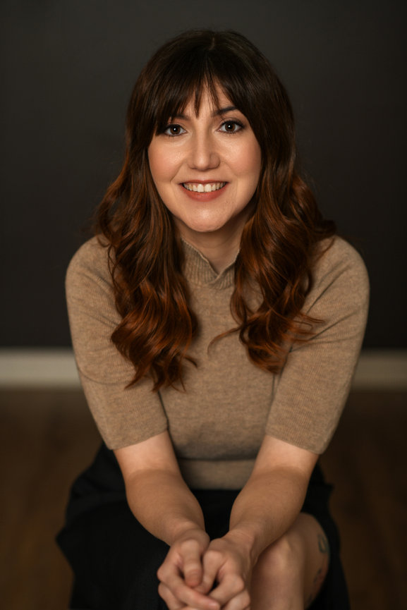 Woman with shoulder-length wavy hair wearing beige top during natural, modern headshot session in Dublin Ohio