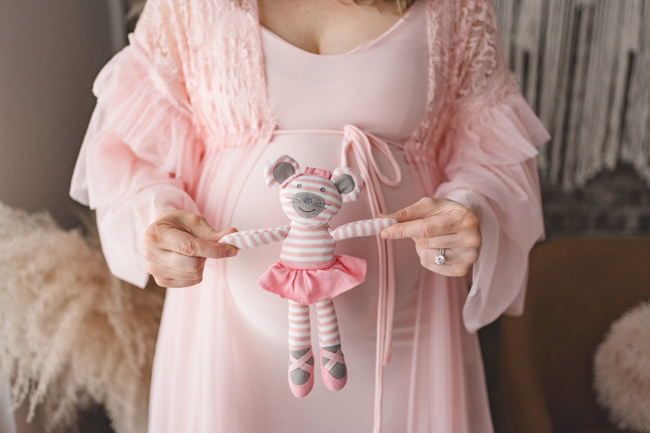 maternity photos of a mama wearing a beautiful pink maternity dress