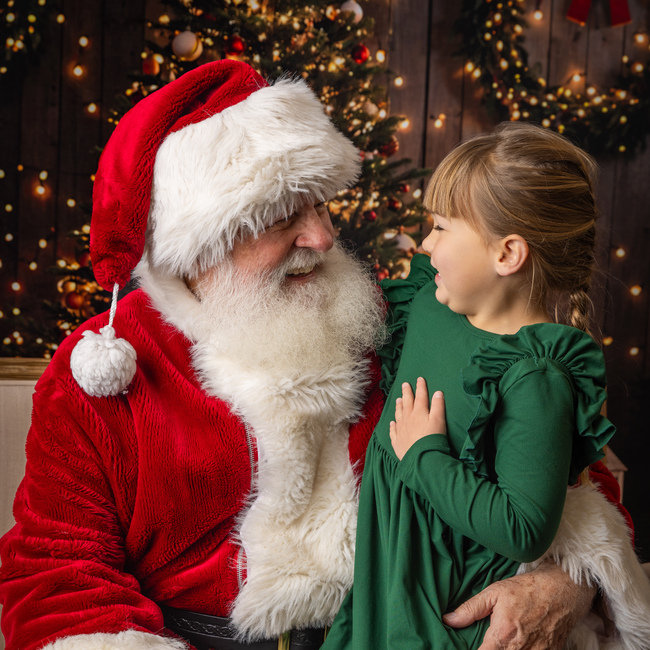 Santa and a child together during a past session